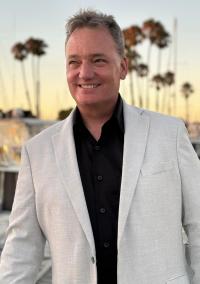 David Sheridan in a white sport coat at sunset