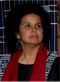 Chimbuko Tembo wearing a black buba and red scarf